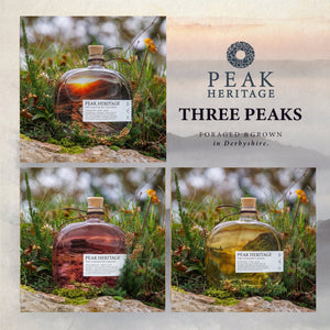 Three glass bottles with cork stoppers and white labels reading 'PEAK HERITAGE' and 'THREE PEAKS FORAGED & GROWN in Derbyshire' are arranged in a collage outdoors on grass and rocks, with a beige branded panel on the right.